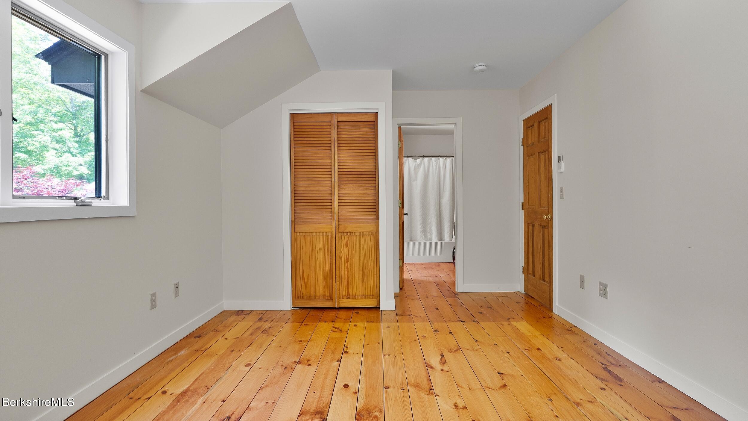 173 Hillsdale Road Egremont, MA 01230 - Photo 68 of 82 an empty room with wooden floor and windows