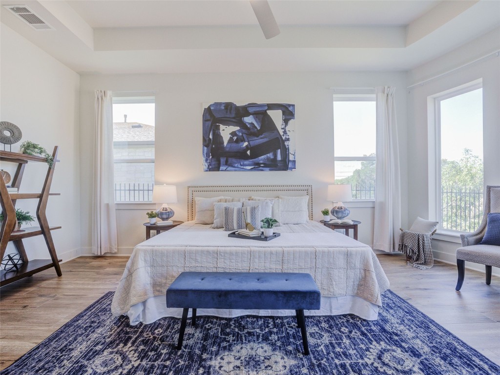 345 Two Creeks Lane Austin, TX 78737 - Photo 17 of 40 a bedroom with a bed and wooden floor