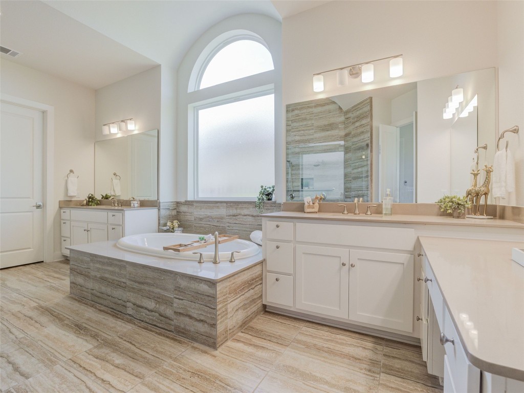 345 Two Creeks Lane Austin, TX 78737 - Photo 21 of 40 a bathroom with a double vanity sink and a mirror