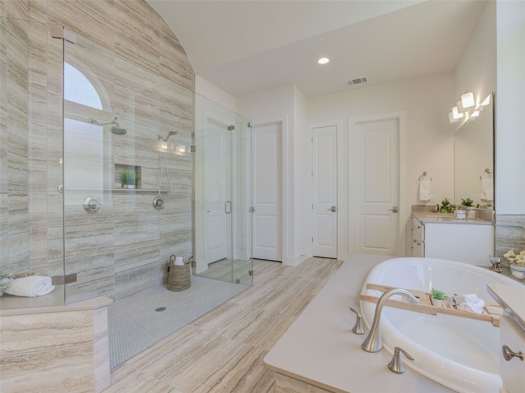 345 Two Creeks Lane Austin, TX 78737 - Photo 22 of 40 a bathroom with a tub a sink and a shower