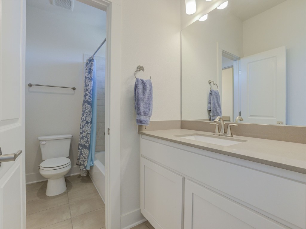 345 Two Creeks Lane Austin, TX 78737 - Photo 30 of 40 a bathroom with a toilet sink and mirror