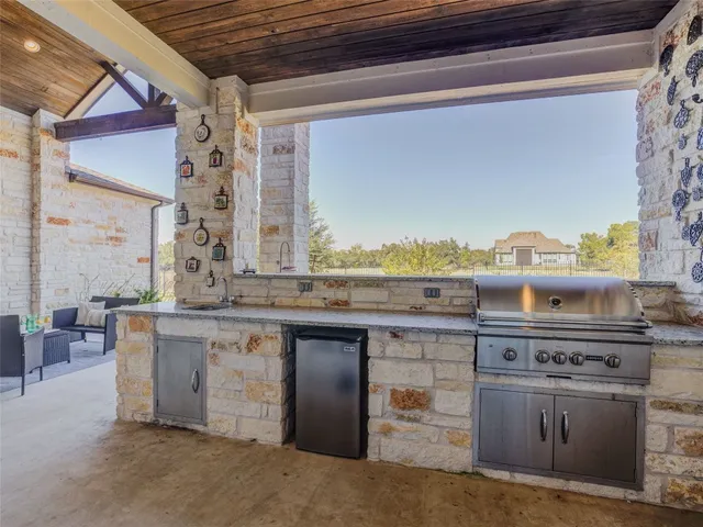 a kitchen with stainless steel appliances granite countertop a stove and a sink