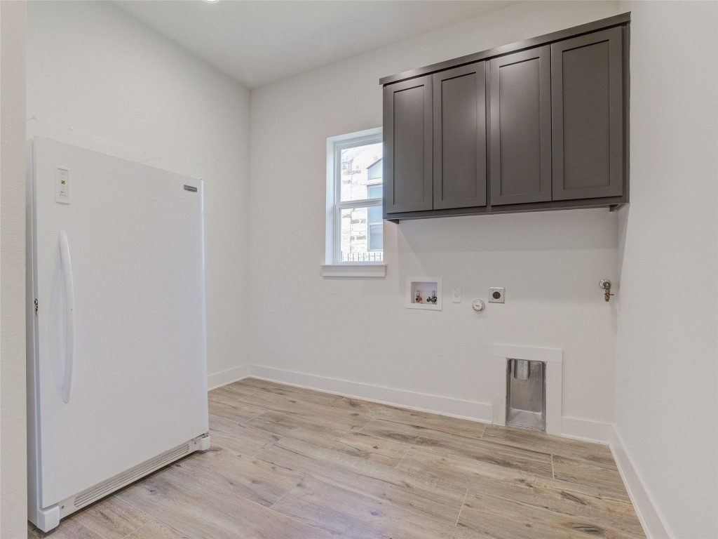 345 Two Creeks Lane Austin, TX 78737 - Photo 38 of 40 a view of an empty room with wooden floor and a window