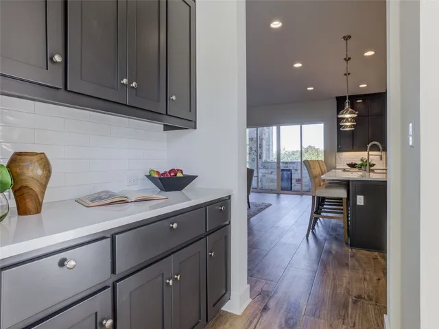 a kitchen with granite countertop lots of counter top space and cabinets
