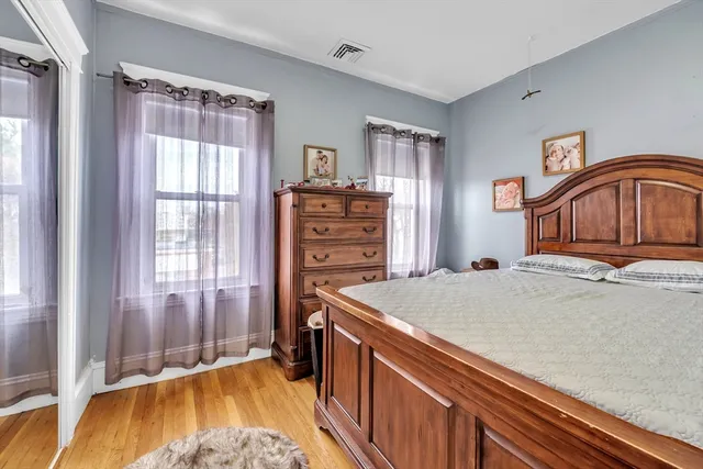 a bedroom with a bed and a dresser