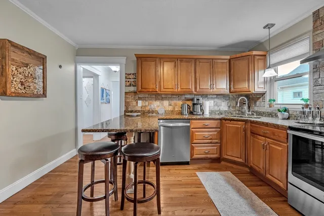 a kitchen with granite countertop wooden cabinets and white appliances