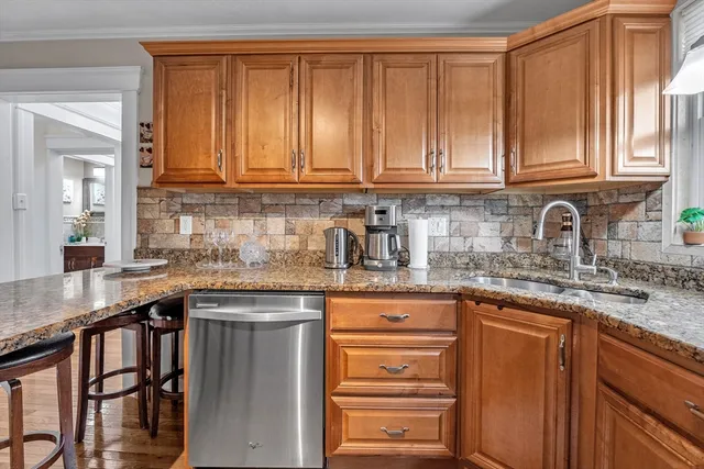a kitchen with stainless steel appliances granite countertop a sink stove and cabinets