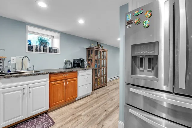 a kitchen with stainless steel appliances granite countertop a refrigerator and a stove top oven