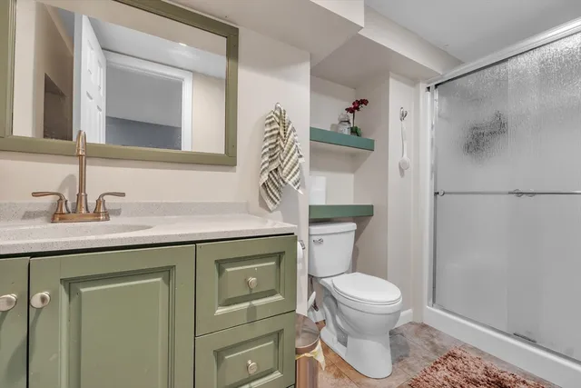 a bathroom with a toilet a sink and mirror