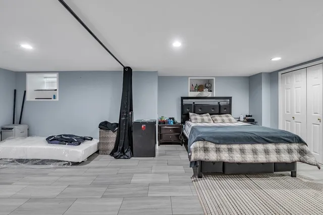 a bedroom with a bed and a couch