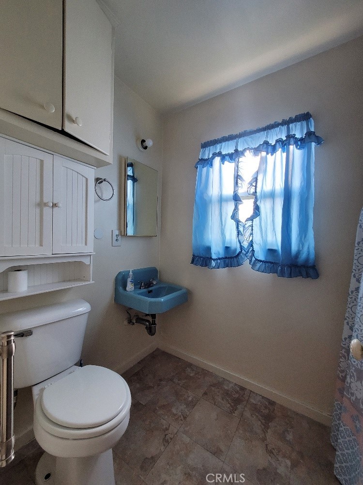 14030 Dittmar Drive Whittier, CA 90605 - Photo 12 of 32 a bathroom with a toilet a sink and a window