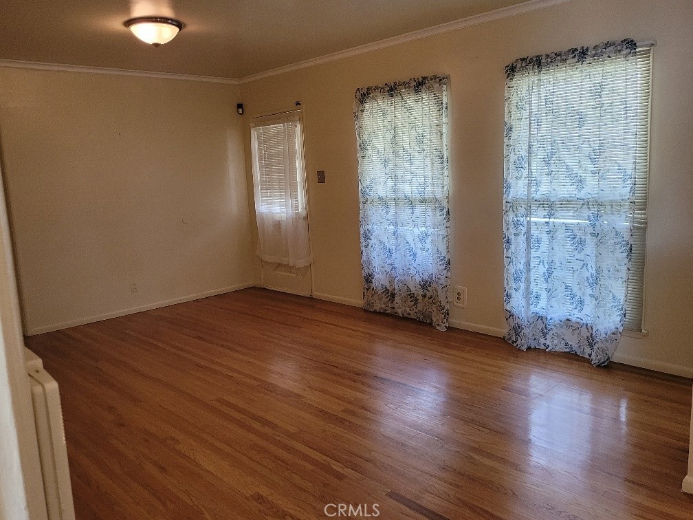14030 Dittmar Drive Whittier, CA 90605 - Photo 7 of 32 an empty room with wooden floor and windows