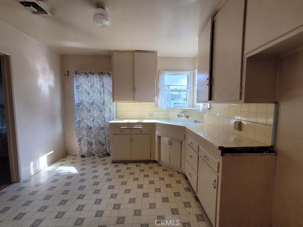 14030 Dittmar Drive Whittier, CA 90605 - Photo 10 of 32 a kitchen with a sink a stove a refrigerator and a sink