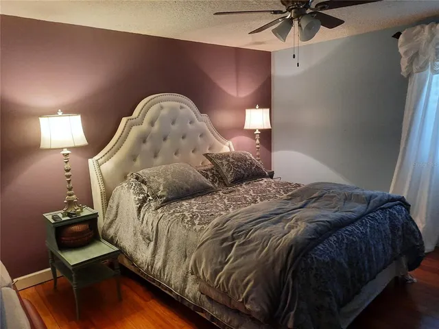 a bed sitting in a bedroom next to a lamp