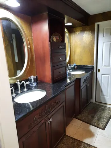a bathroom with a double vanity sink and a mirror