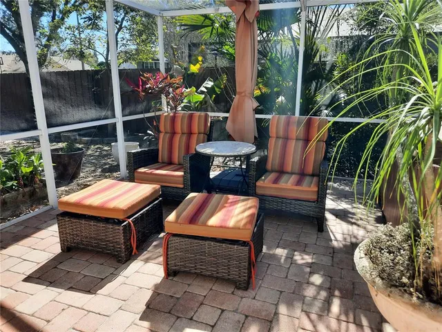 a backyard of a house with barbeque oven table and chairs