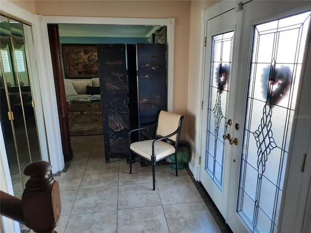 a view of a hallway with furniture and front door