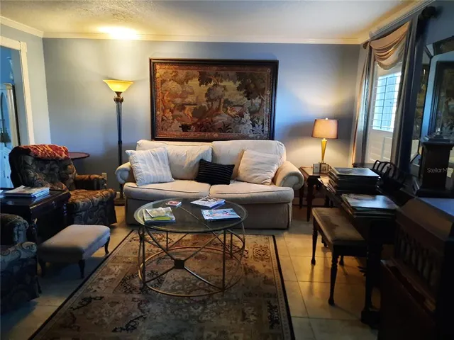 a living room with furniture and a lamp