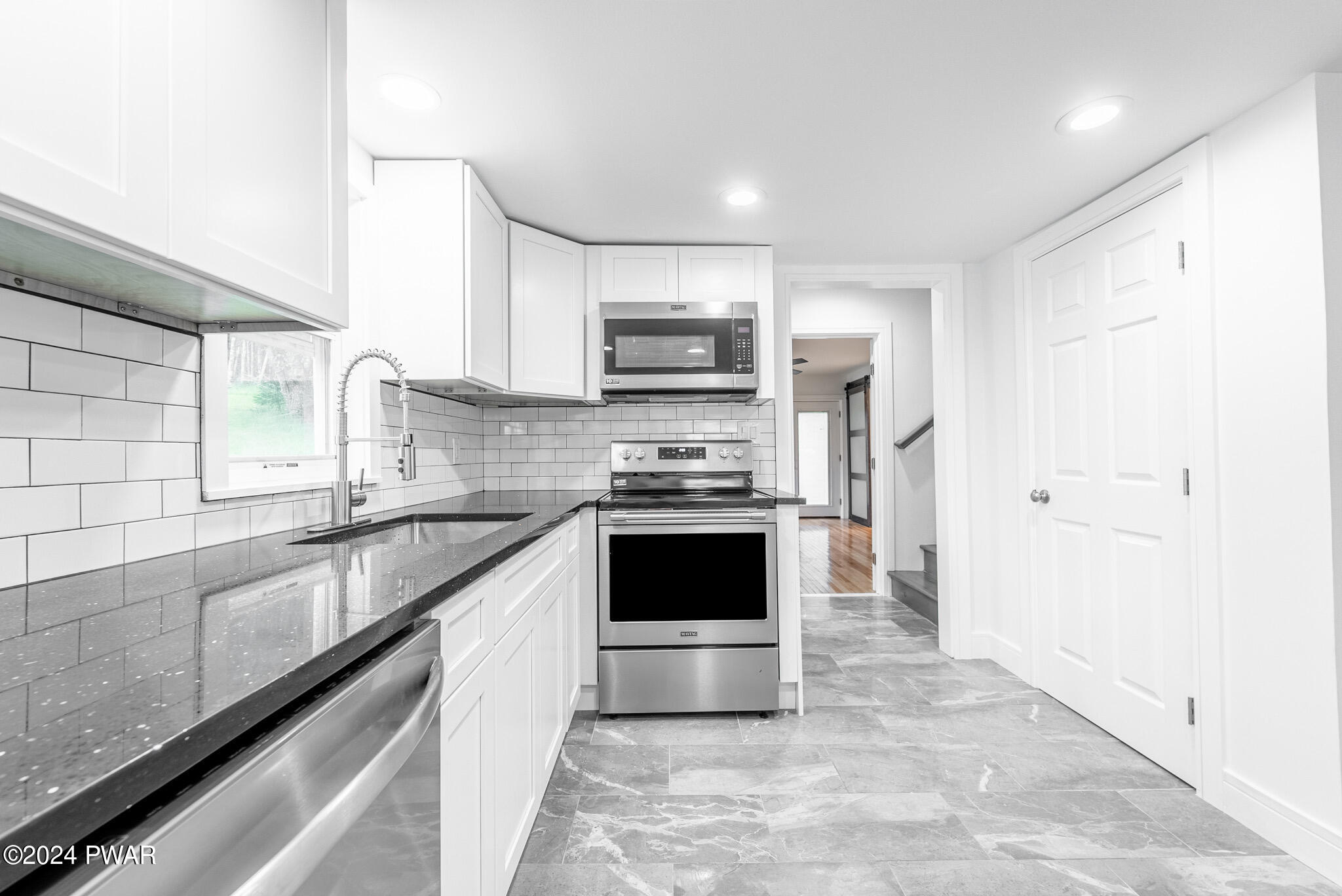144 Log Tavern Road Milford, PA 18337 - Photo 21 of 45 a large kitchen with granite countertop a stove and a sink