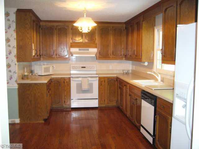 4500 Oakcliffe Road Greensboro, NC 27406 - Photo 4 of 11 Kitchen. Excellent kitchen with plenty of workspace and generous cabinet storage - lower shelves roll out for extra convenience!