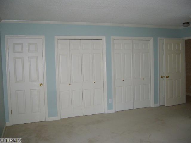 4500 Oakcliffe Road Greensboro, NC 27406 - Photo 9 of 11 Master Bedroom. Attractive wall of closets provides generous storage