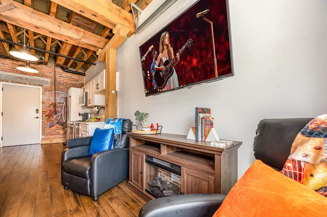 a living room with furniture and wooden floor