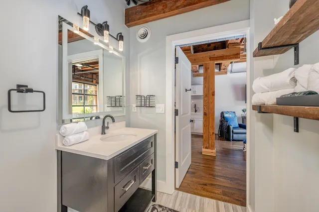 a bathroom with a sink a mirror and shower