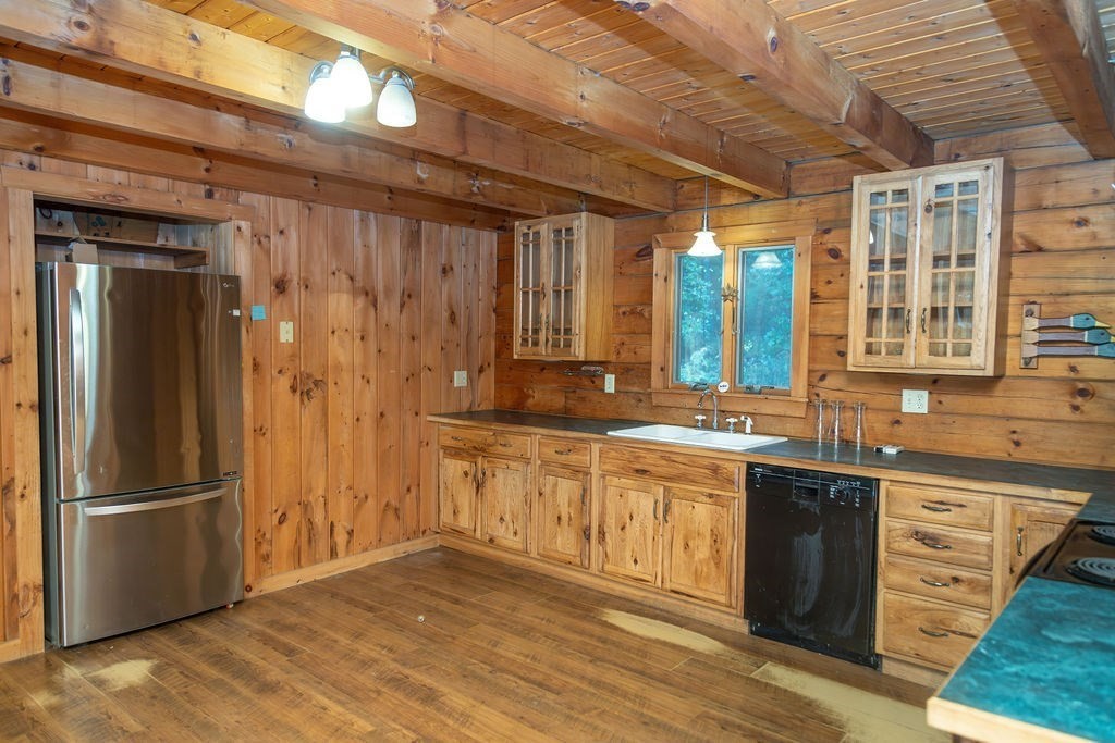 119 Long Plain Road Leverett, MA 01054 - Photo 14 of 38 a kitchen with stainless steel appliances granite countertop a refrigerator a sink dishwasher a stove and white countertops with wooden floor
