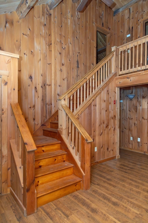 119 Long Plain Road Leverett, MA 01054 - Photo 21 of 38 a view of staircase with lots of frames on wall and a wooden floor