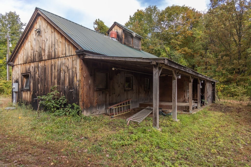 119 Long Plain Road Leverett, MA 01054 - Photo 10 of 38 a view of a barn house next to a yard with wooden fence