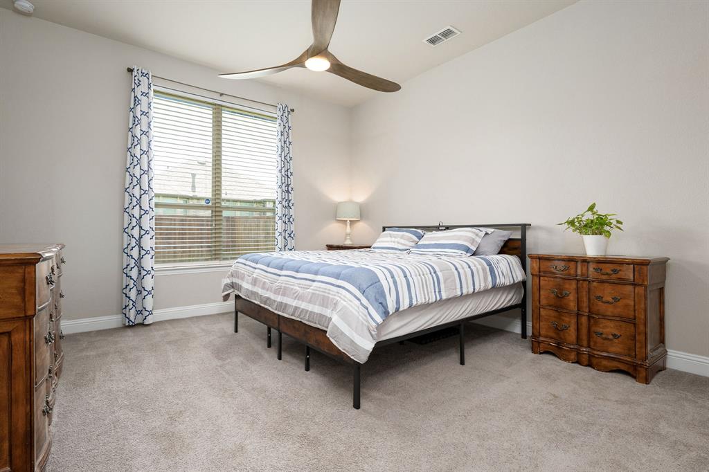 1320 Rosebush Road Aubrey, TX 76227 - Photo 17 of 33 a bedroom with a bed dresser and a window