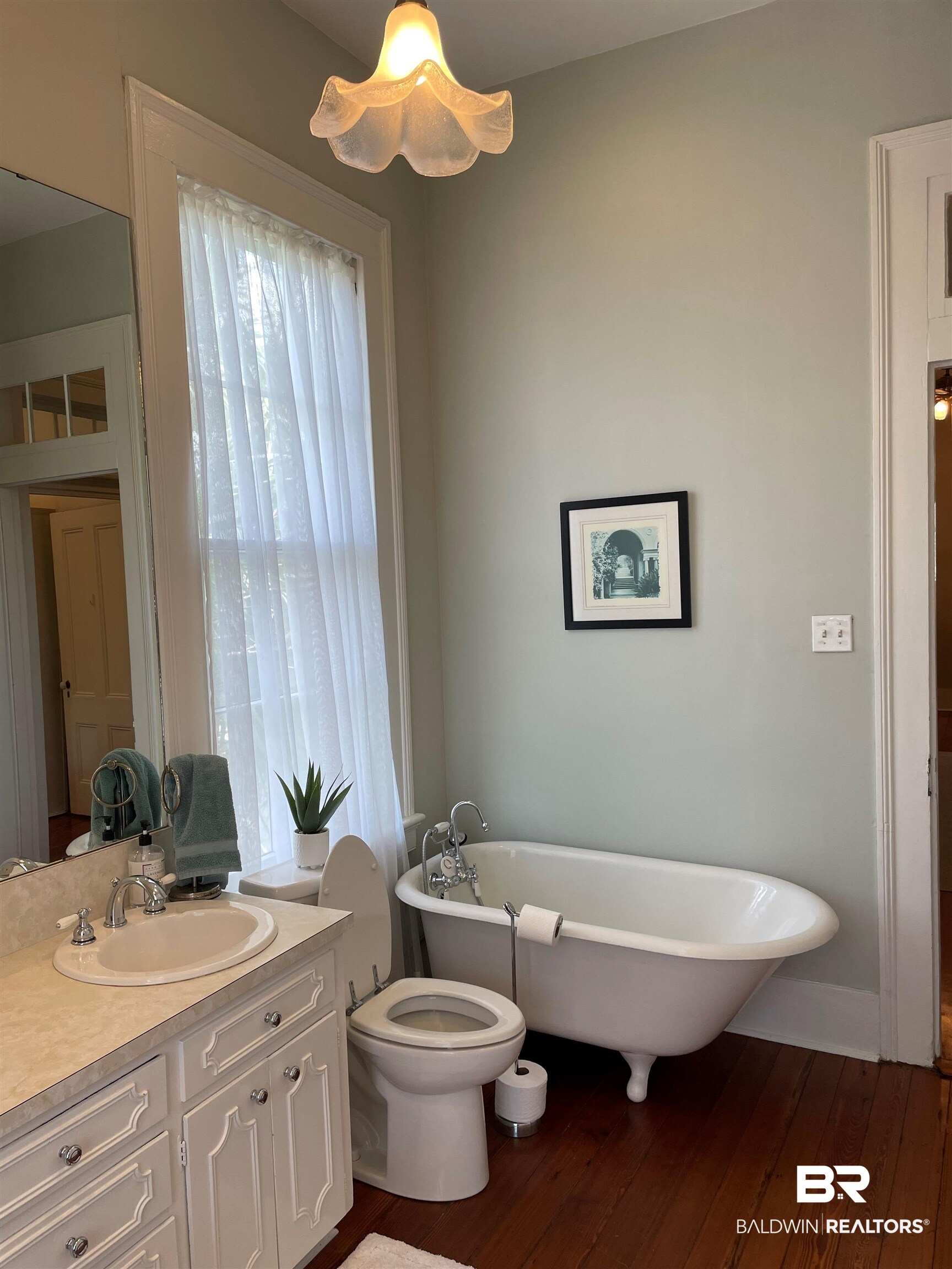 1001 Augusta Street Mobile, AL 36604 - Photo 26 of 26 Bathroom featuring vanity, a tub, hardwood / wood-style flooring, and toilet