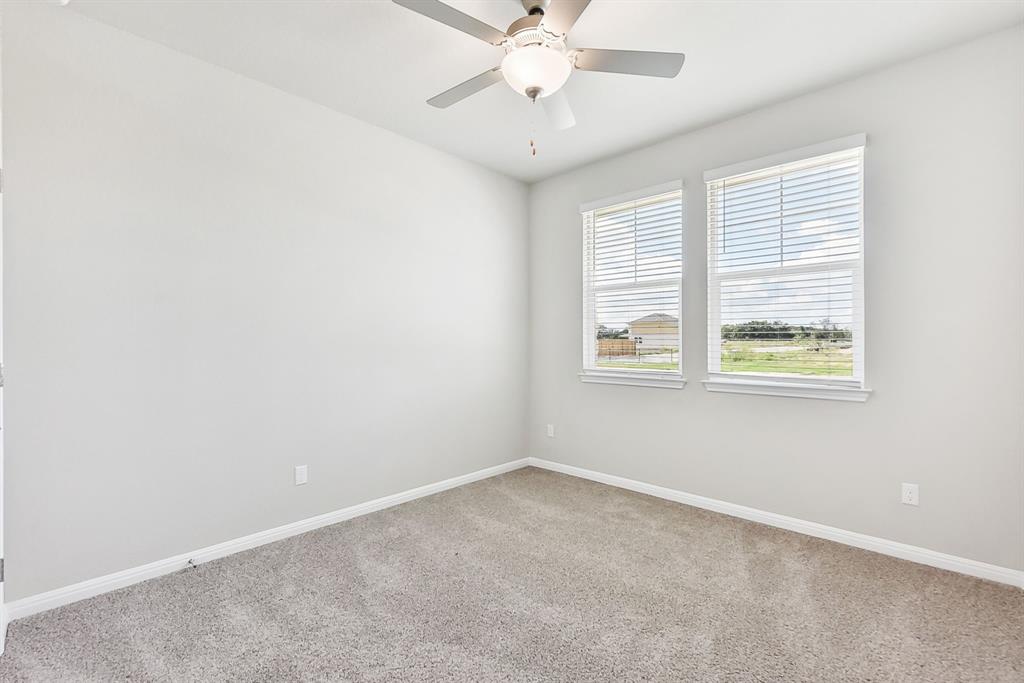 181 Old Town Road Kyle, TX 78640 - Photo 20 of 32 Plush carpeting and dual windows illuminate this versatile secondary space.