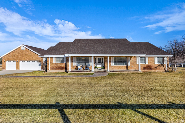 1060 West 2620th Street South Mapleton, UT 84664 - Photo 77 of 87 View of front of house featuring a front yard, a porch, and brick siding