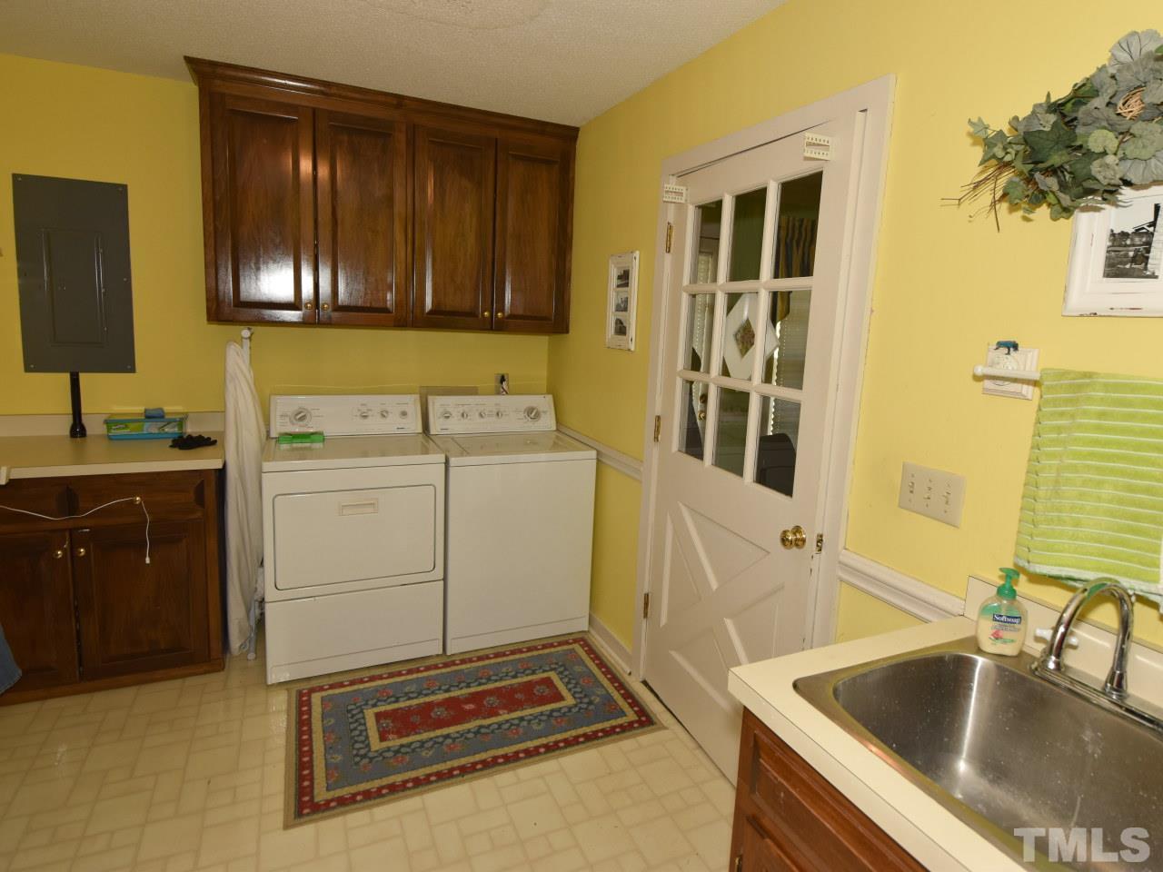 350 Sullivan Road Selma, NC 27576 - Photo 20 of 25 Laundry room /mudroom with cabinets, mud sink, work area for folding, ironing. dry area.