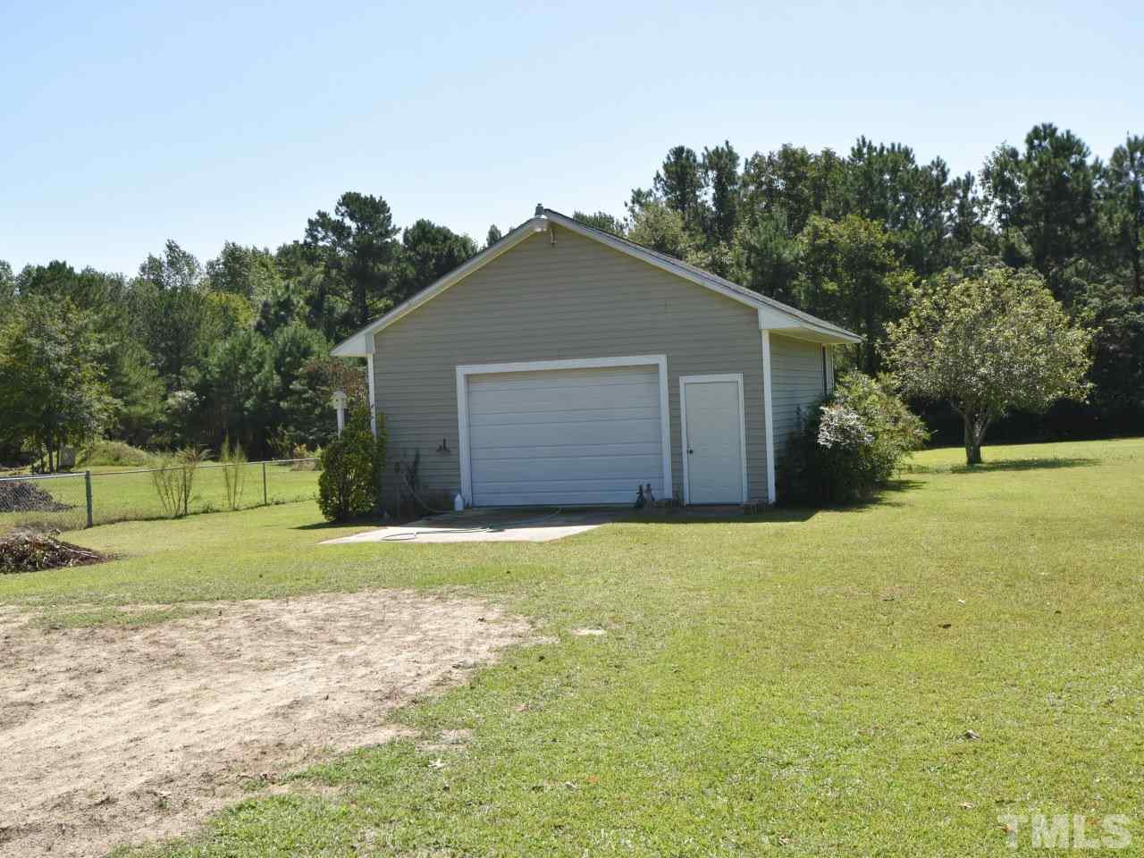 350 Sullivan Road Selma, NC 27576 - Photo 23 of 25 Detached heated workshop with rollup door. 24x26 with concrete pad.