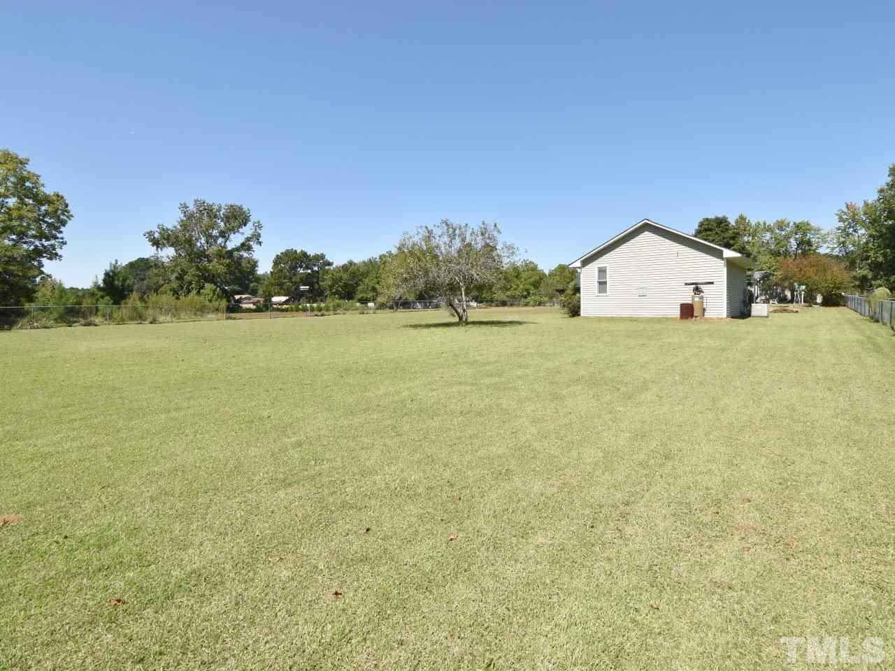 350 Sullivan Road Selma, NC 27576 - Photo 24 of 25 1.22 acre lot, partially fenced, garden spot, leantoo on back of garage for additional storage.