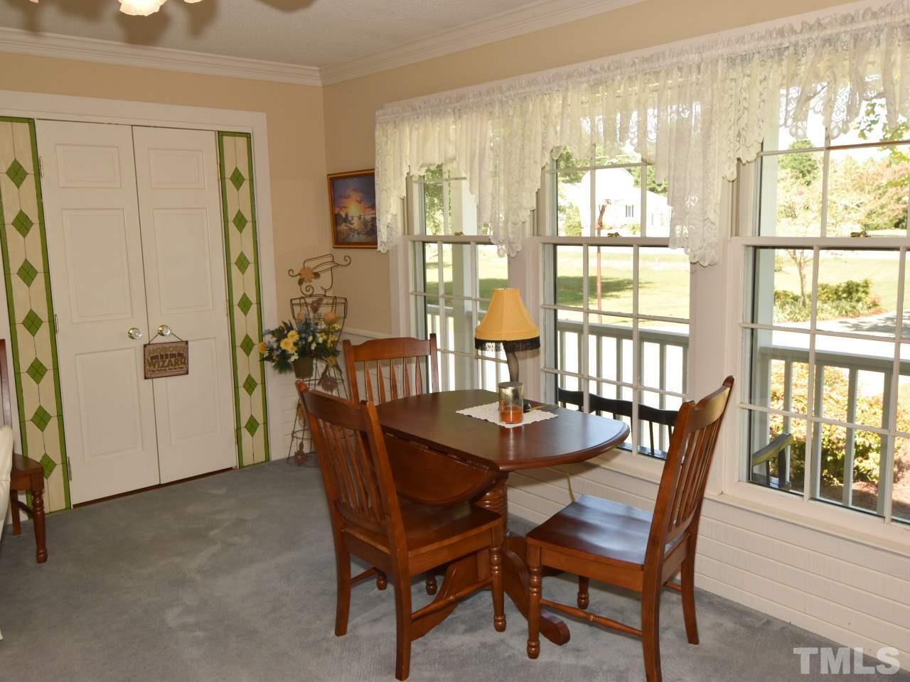 350 Sullivan Road Selma, NC 27576 - Photo 5 of 25 Enjoy dining by a a row of windows providing natural light .