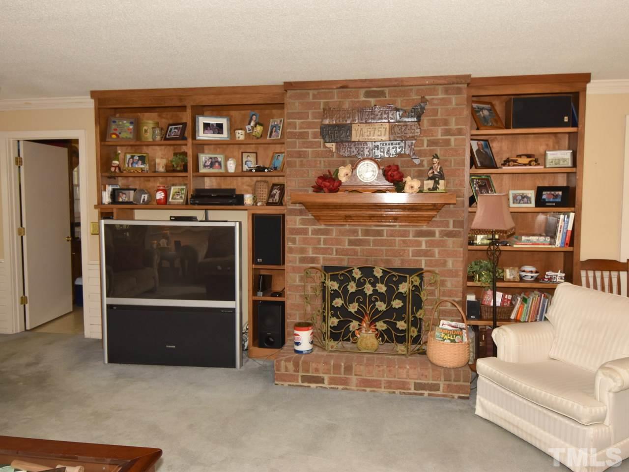 350 Sullivan Road Selma, NC 27576 - Photo 6 of 25 Large brick fireplace is the focal point for family gatherings.