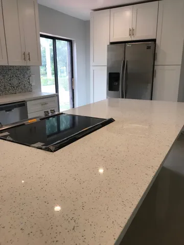 a kitchen with a refrigerator and a sink