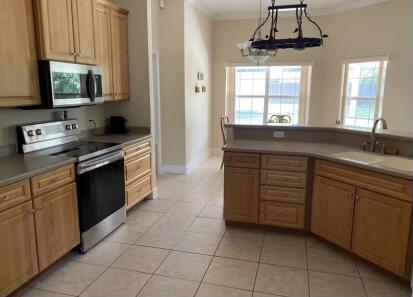 10 Maple Avenue Shalimar, FL 32579 - Photo 12 of 21 a kitchen with stainless steel appliances granite countertop a stove a sink and a microwave