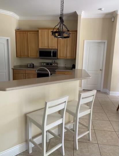 10 Maple Avenue Shalimar, FL 32579 - Photo 14 of 21 a kitchen with a table chairs refrigerator and microwave