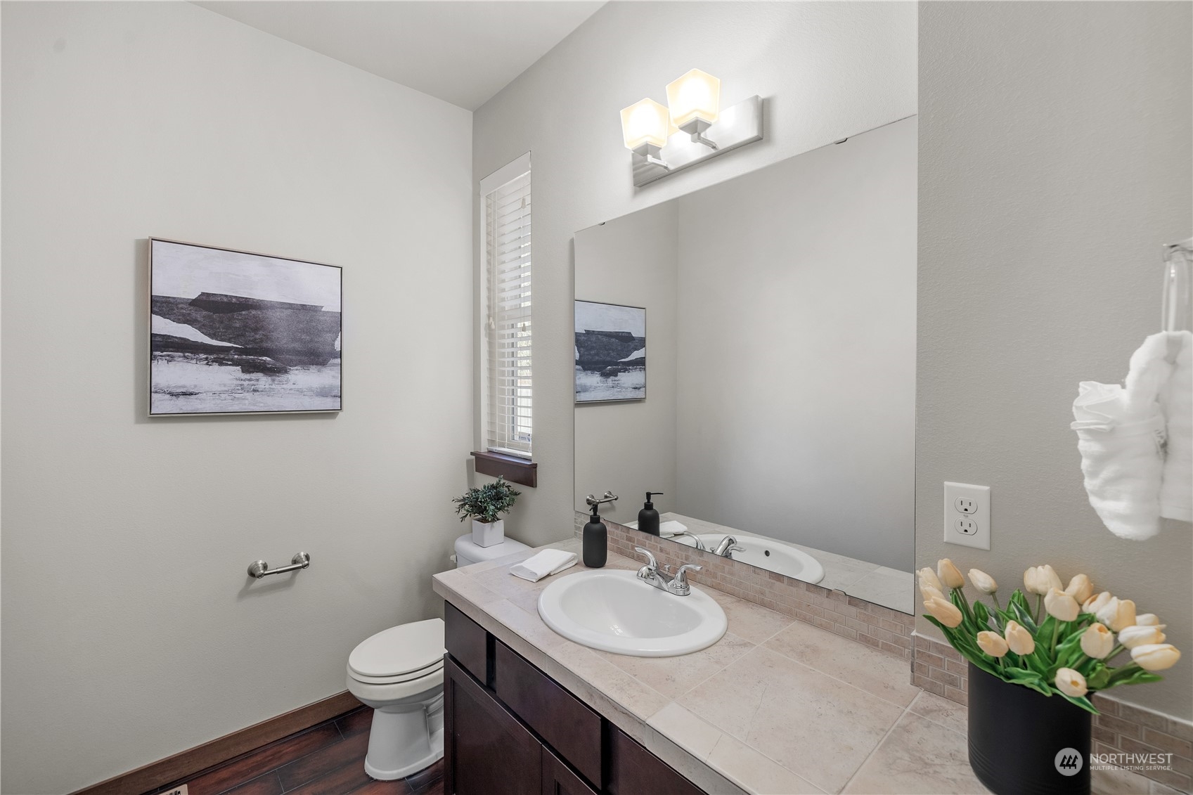 23012 Barker Road Bothell, WA 98021 - Photo 21 of 30 a bathroom with a granite countertop toilet a sink and a mirror