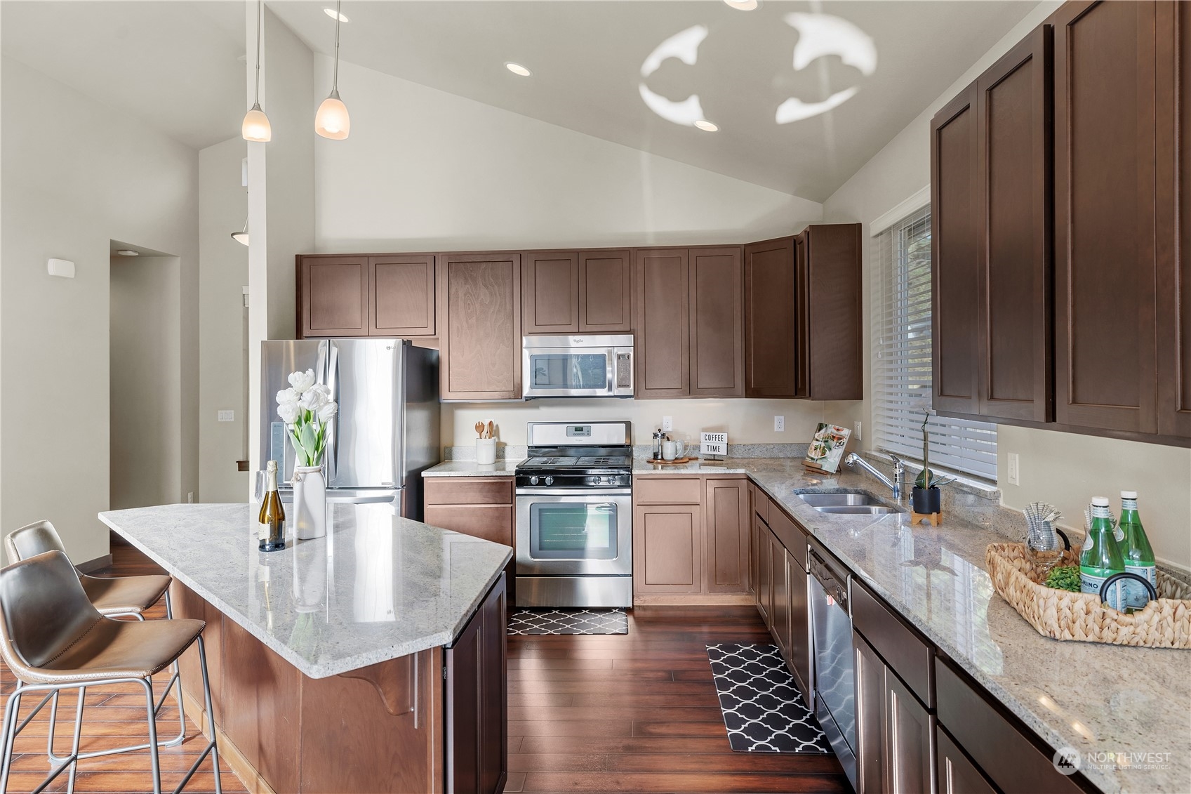 23012 Barker Road Bothell, WA 98021 - Photo 6 of 30 a kitchen with stainless steel appliances granite countertop a sink refrigerator and cabinets