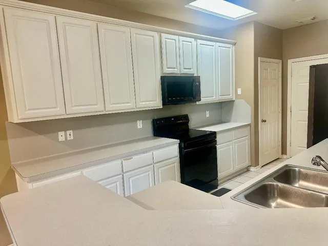 a kitchen with a sink and cabinets
