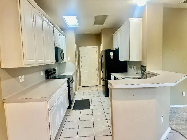 a kitchen with a sink a stove and refrigerator