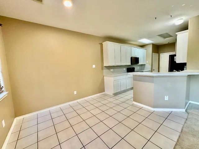 a kitchen with stainless steel appliances a refrigerator and a stove top oven