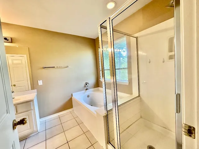 a bathroom with a tub and shower