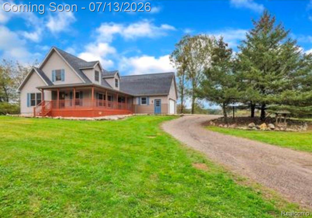 12601 Angle Road Bath, MI 48808 - Photo 1 of 2 Two-story home with a wrap-around porch and attached garage
