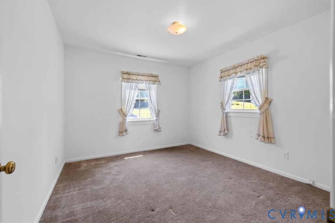 2311 George's Road Powhatan, VA 23139 - Photo 25 of 37 Carpeted room featuring two windows and a flush-mo